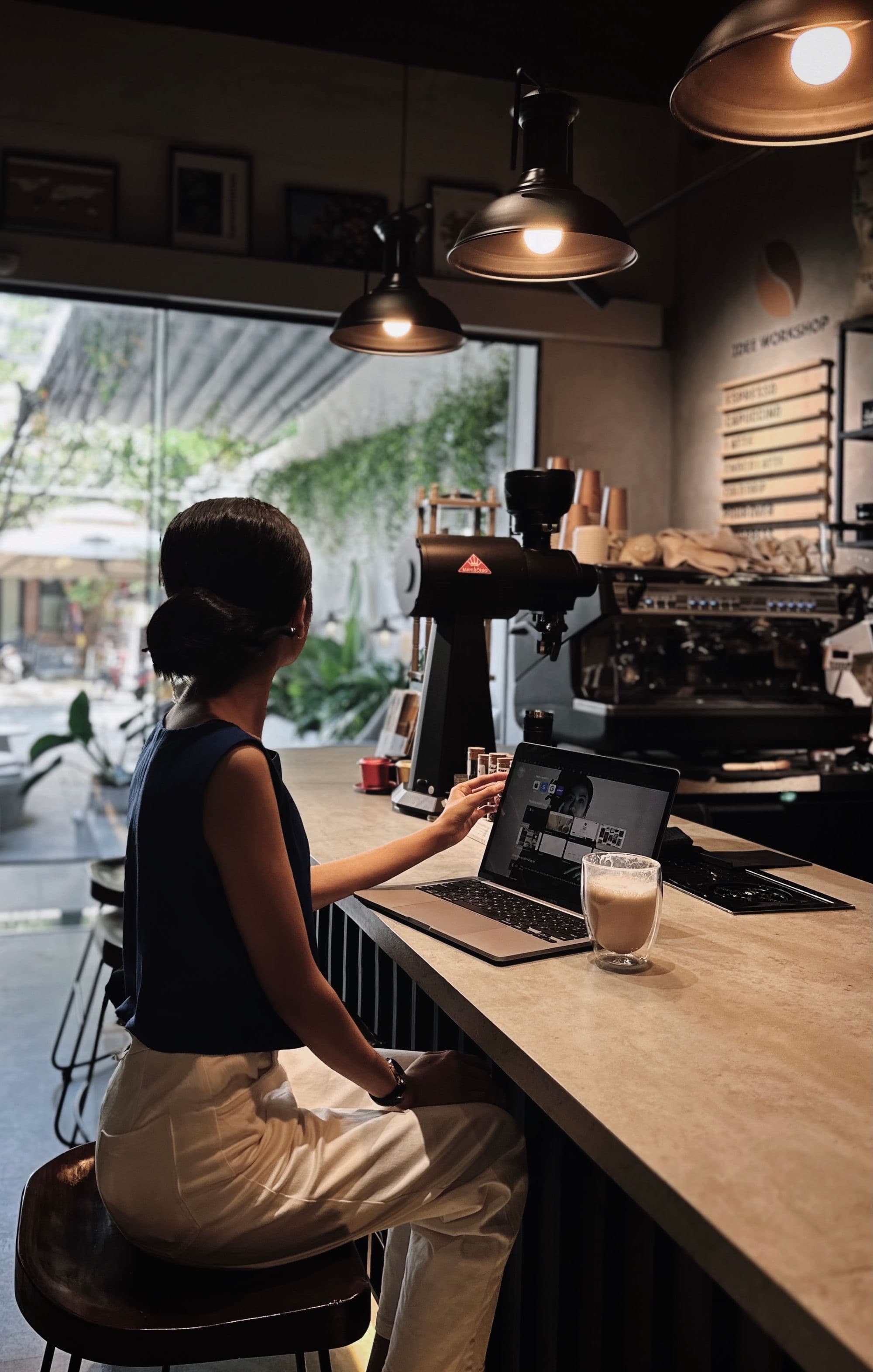 En kvinna arbetar på sin laptop vid en cafédisk